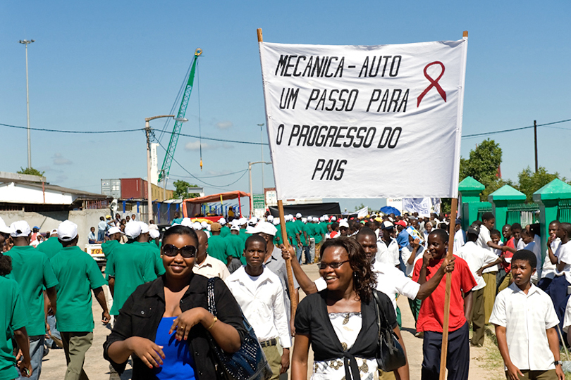 1st of May rally workers carry a banner with &lt;p&gt;HIV/AIDS ribbon to create awareness